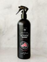 Cleaning Mama plant-based Fresh Scent All Purpose Cleaner in a black spray bottle against a light marble background.