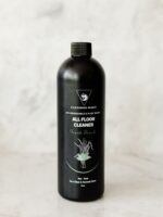 Cleaning Mama non-toxic, plant-based Fresh Scent All Floor Cleaner in a black spray bottle sitting on a marble surface.