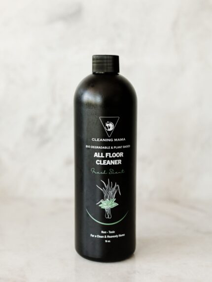 Cleaning Mama non-toxic, plant-based Fresh Scent All Floor Cleaner in a black spray bottle sitting on a marble surface.