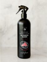 Cleaning Mama non-toxic, plant-based Fresh Scent All Purpose Cleaner in a black spray bottle sitting on a marble countertop.