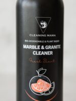 Close-up of the Cleaning Mama plant-based Fresh Scent Marble & Granite Cleaner label with orange citrus artwork on a black bottle.