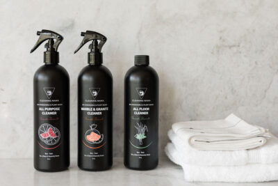 Cleaning Mama Fresh Scent cleaning trio featuring All Purpose, Marble & Granite and All Floor Cleaner beside folded white cleaning cloths.