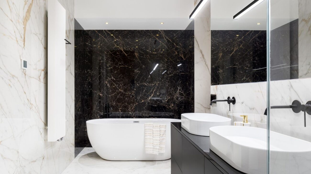 Modern marble bathroom with freestanding tub, double sinks and glass shower