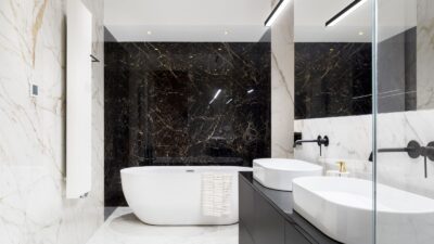 Modern marble bathroom with freestanding tub, double sinks and glass shower