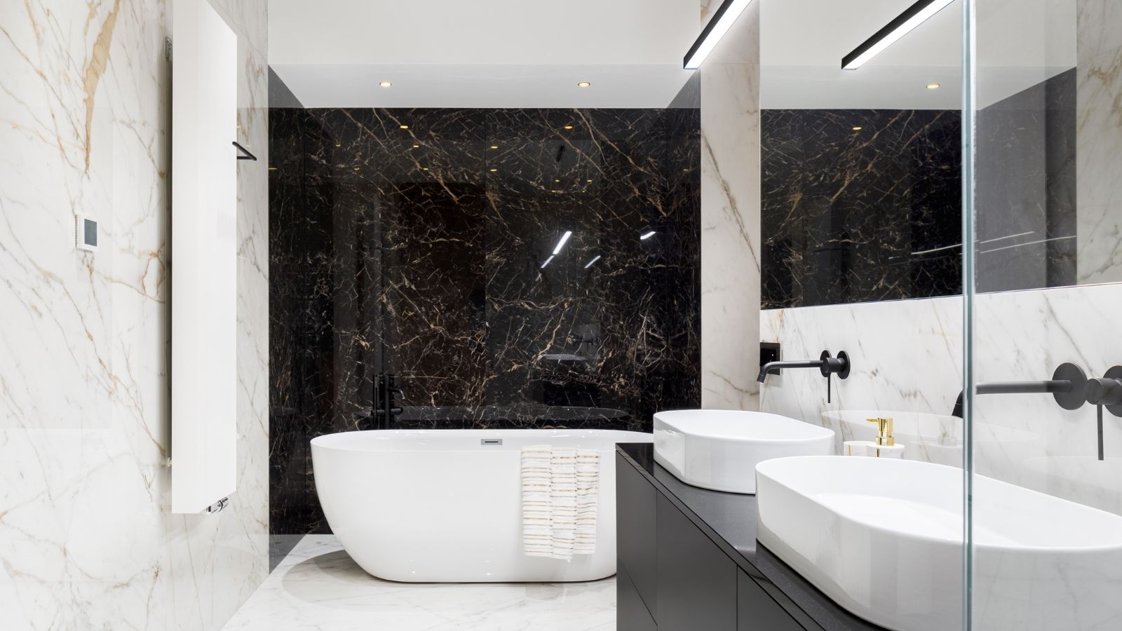 Modern marble bathroom with freestanding tub, double sinks and glass shower