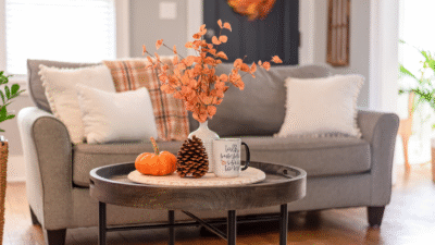 Pumpkins and dried fall foliage arranged on a coffee table for autumn decorating